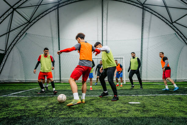 istock Soccer player dribbling ball on field 1384339354