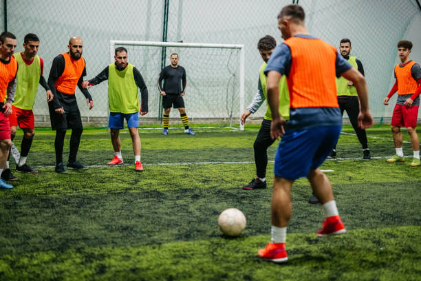 istock Soccer player dribbling ball on field 1384339459