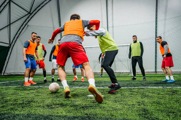 istock Soccer player dribbling ball on field 1384339555