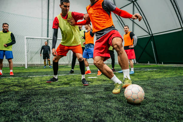 Soccer player dribbling ball on field