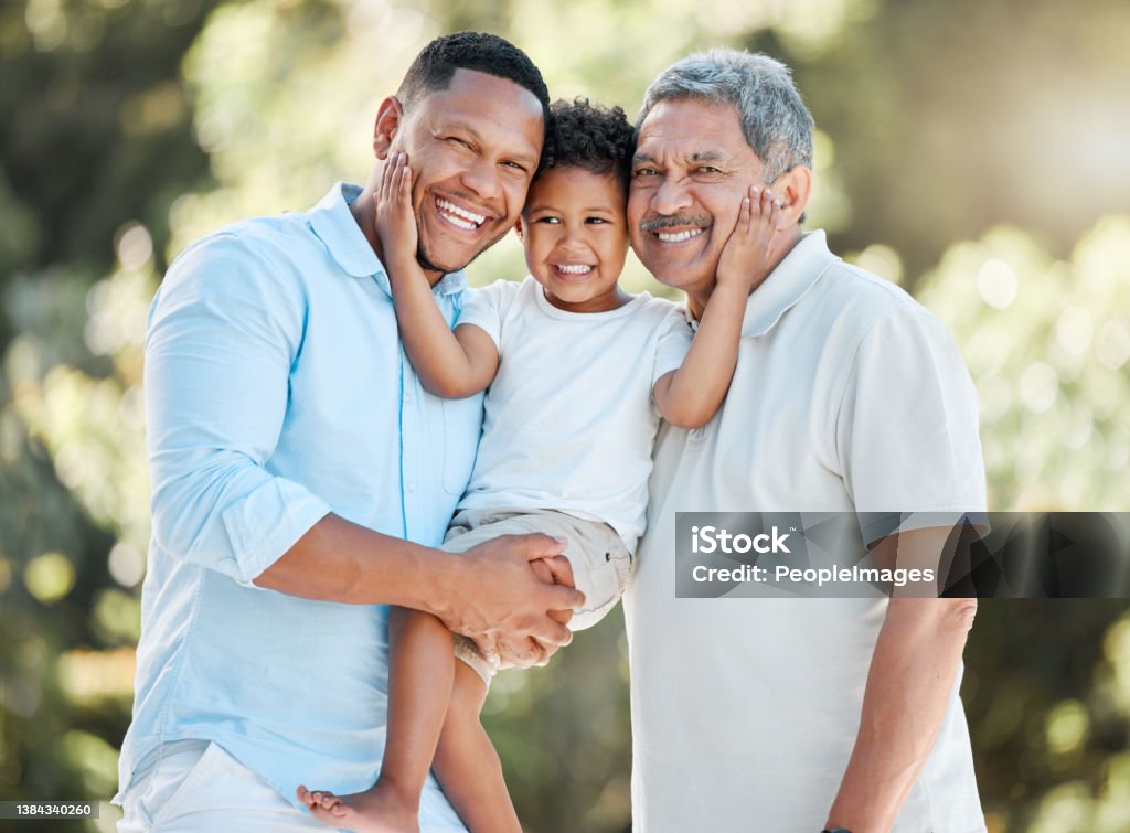 Shot of a little boy posing outside with his father and grandfather If life teaches us anything it's how important family is Father Stock Photo