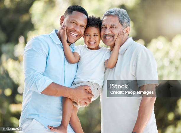 Shot Of A Little Boy Posing Outside With His Father And Grandfather Stock Photo - Download Image Now