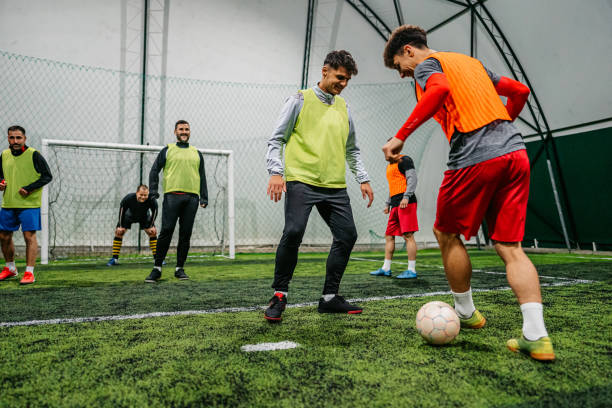 istock Soccer player dribbling ball on field 1384340276