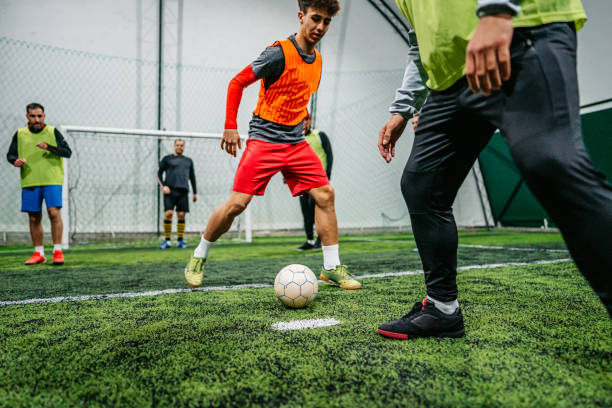 istock Soccer player dribbling ball on field 1384340356
