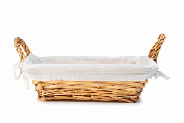 istock Empty wicker bread basket with white napkin isolated on white 1384340431