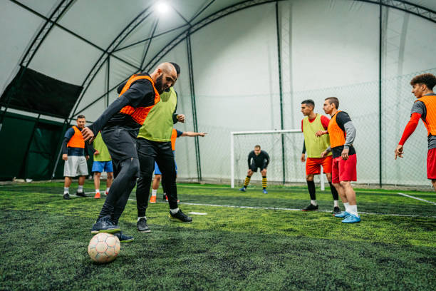 istock Soccer player dribbling ball on field 1384340469