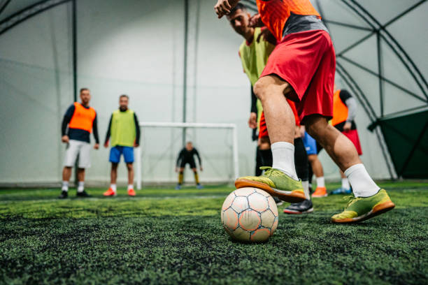 istock Soccer player dribbling ball on field 1384340552