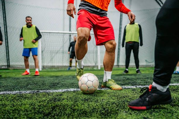 istock Soccer player dribbling ball on field 1384340575