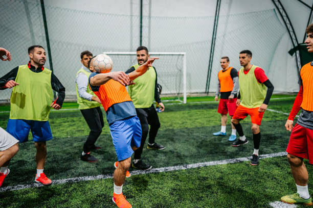 istock Soccer player dribbling ball on field 1384340599
