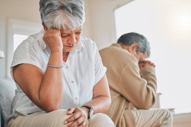 shot of a senior couple ignoring each other during an argument at home - arguing senior adult conflict couple imagens e fotografias de stock