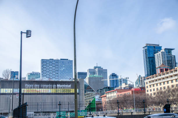 Montreal convention center besides skyscrapers during winter day
