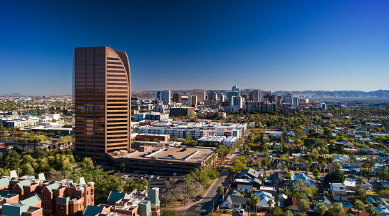 Downtown Phoenix and South Mountain in the background with neighborhoods and the BMO Tower (formerly Dial Tower) in the foreground.