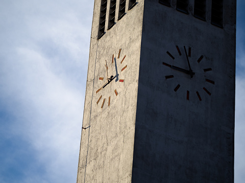Modern Minimalist Tower Clock Closeup with Overcast Sky