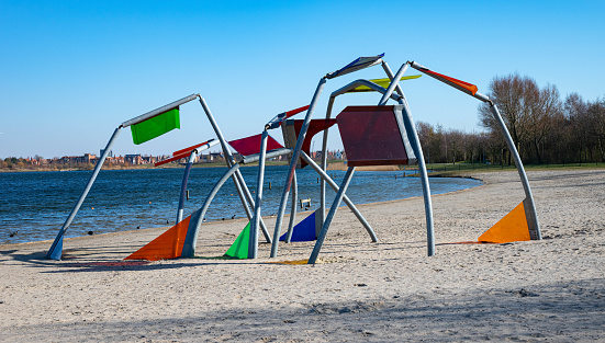 beautiful diverse colored playground equipment on a beach in a park called  toolenburgse plas in Hoofddorp The Netherlands