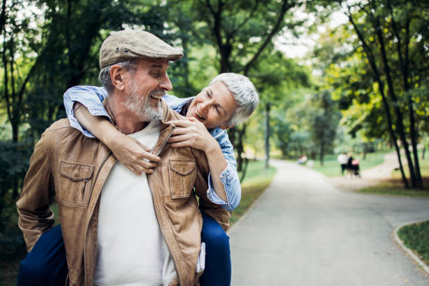 istock Happy seniors having fun together in the park 1384369409