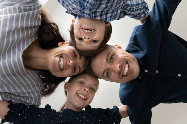 istock Bottom view faces family with kids smile looking at camera 1384369498