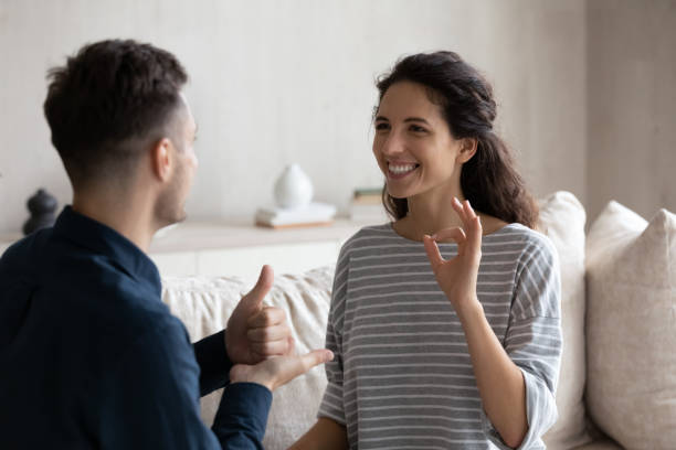 istock Latina woman communicates with man using sign language 1384369532