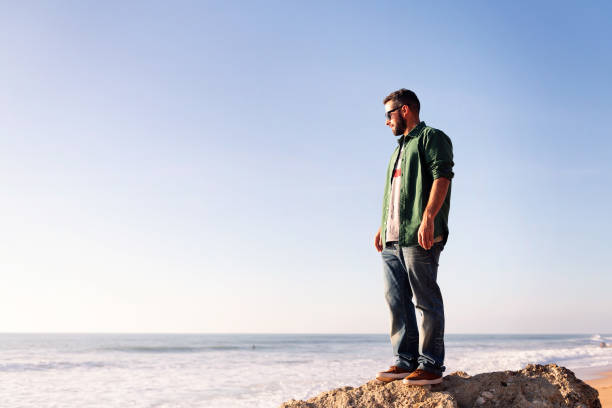 istock bearded man with sunglasses looking the sea 1384369688