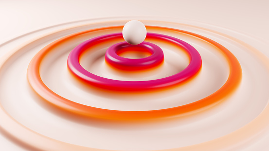 A sphere rising from the surface and forming concentric waves