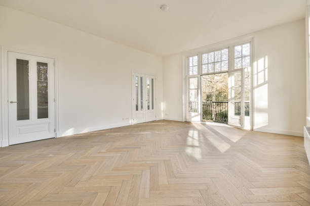 istock Empty room interior background with parquet floor and white walls 1384382507