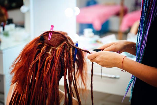 istock Braiding process african plaits with colored kanekalon. 1384414716