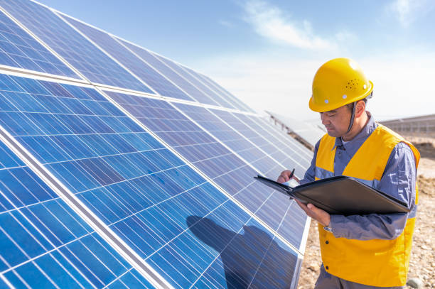 istock Asian middle-aged male power engineer is working at solar power station 1384419481