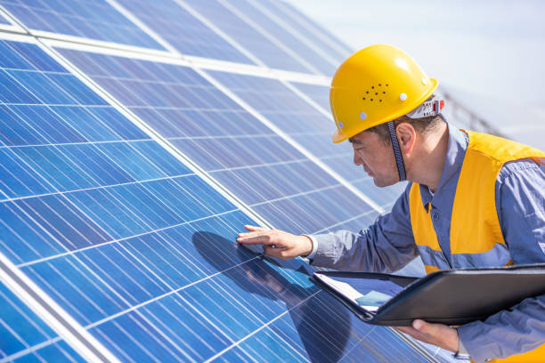 istock Asian middle-aged male power engineer is working at solar power station 1384419993