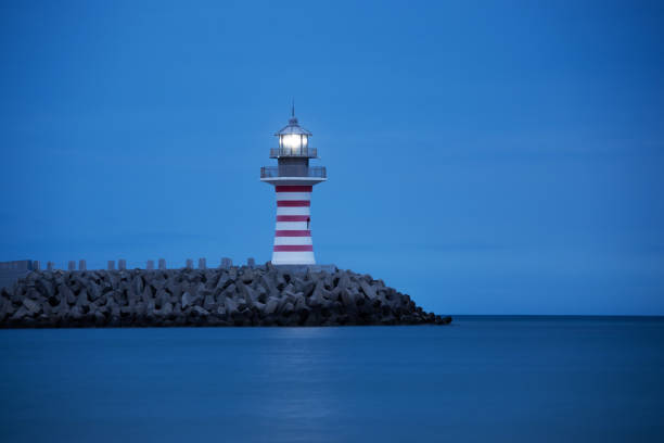 Lighthouse by the sea at night