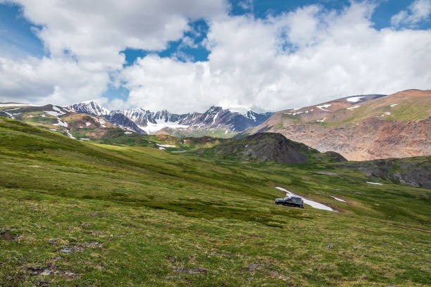 istock mountains glacier snow car grass sky clouds summer 1384420691