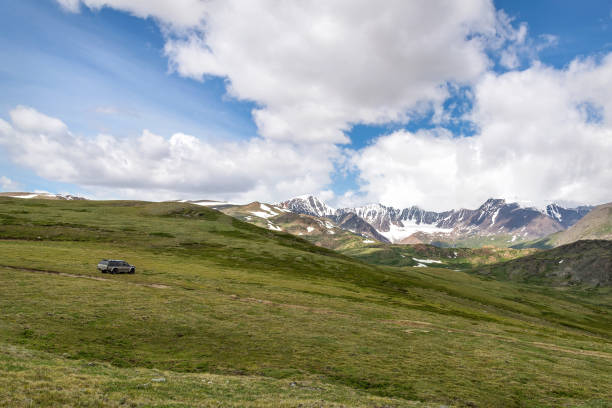 istock mountains glacier snow car grass sky clouds summer 1384420812
