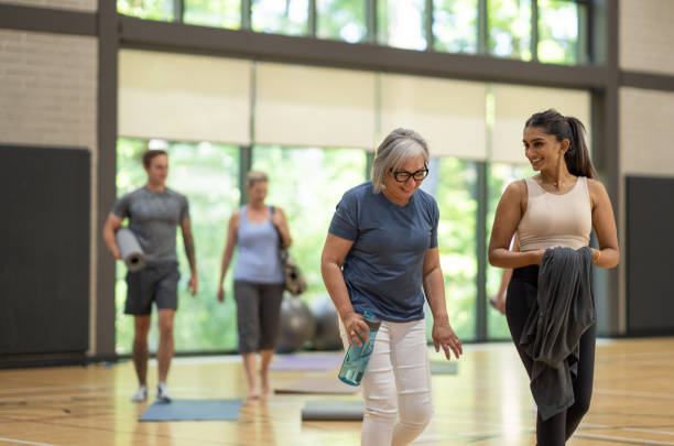 istock Adults Walking Into Yoga Class 1384422465