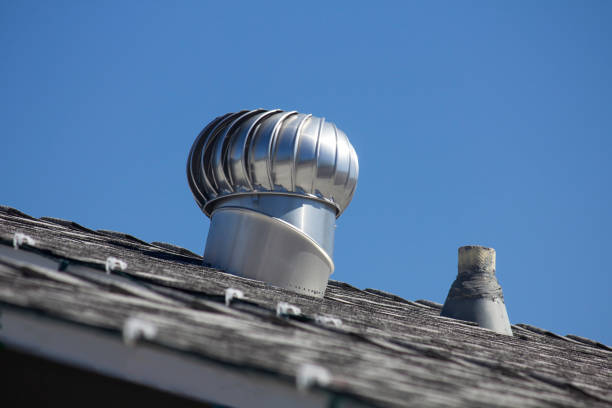 istock Silver Wind Turbine On Roof 1384423369