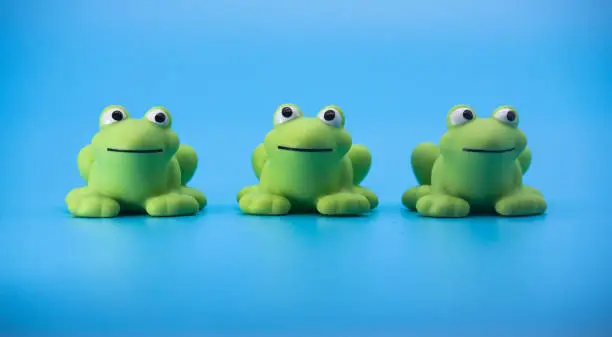 Photo of Three Cute Little Green Frogs