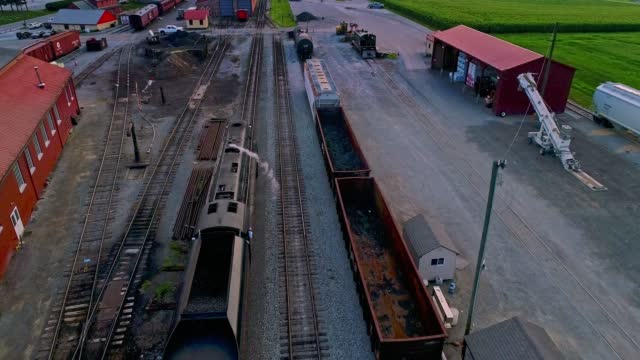 Aerial View from Slightly behind a Steam Passenger Entering a Freight Yard heading Towards the Station