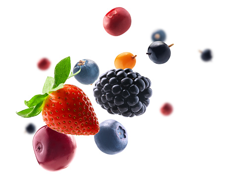 Many different berries in the form of a frame on a white background.