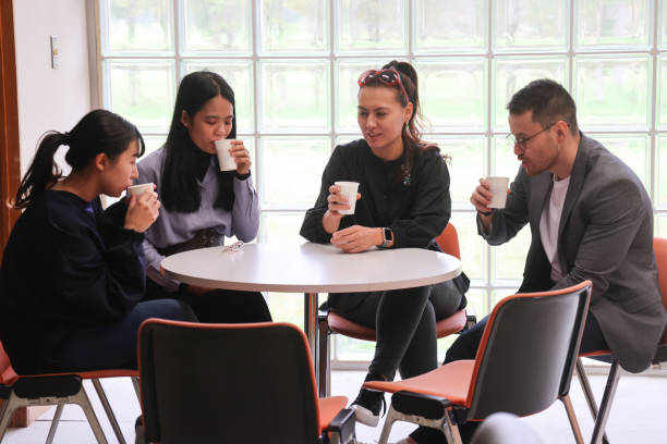 istock Graduate students talking and drinking at launge of University 1384428599