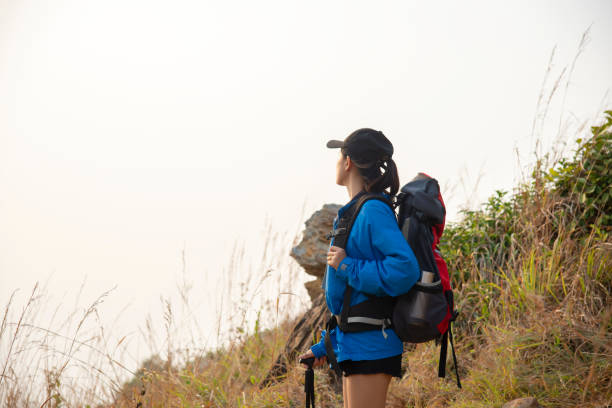 istock Hiker with backpack relaxing young woman hiking holiday 1384433283