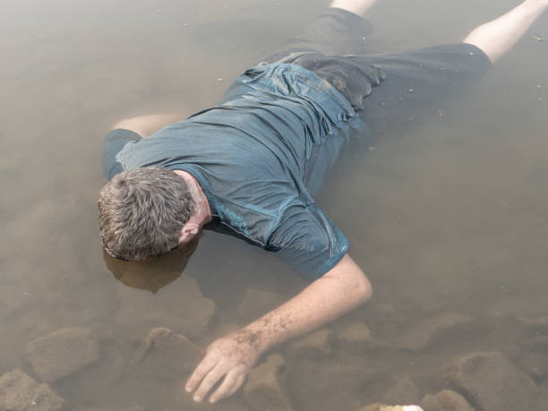 a corpse in the water, the body of a dead man was found by the lake near the pond, a drowned man was found a corpse in the water, the body of a dead man was found by the lake near the pond, a drowned man was found. fish blood stock pictures, royalty-free photos & images
