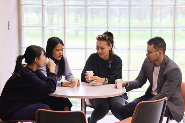 istock Graduate students talking and drinking at launge of University 1384447221