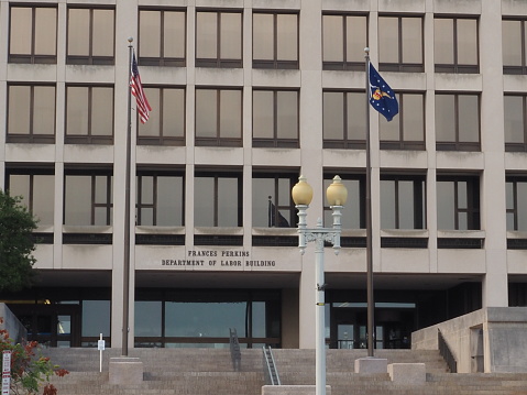 Washington D.C., District of Columbia, United States - August 14 2021: Department of Labor building of the United States of America with flag. Manages the Bureau of Labor Statistics.