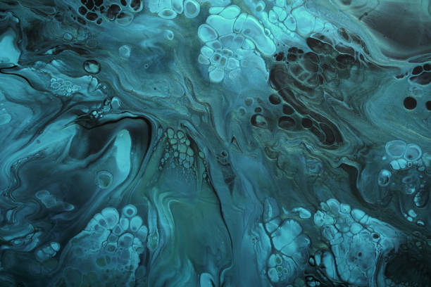 istock Fluid Art. Fluorescent blue waves with golden particles on black background. Marble effect background or texture 1384453241