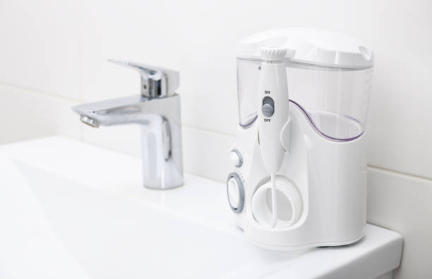 istock Irrigator on the sink in a white bathroom. 1384455123