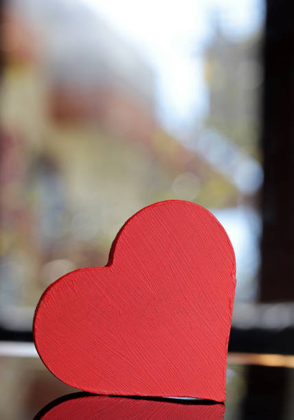 Decorative balls and a heart on a red background, 3D rendering.