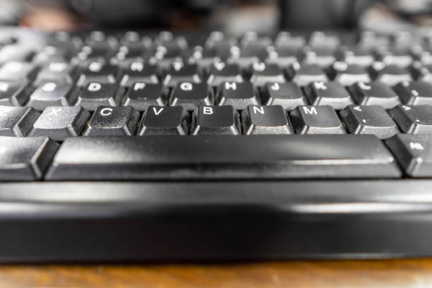 Close-up black keyboard on top of wooden table