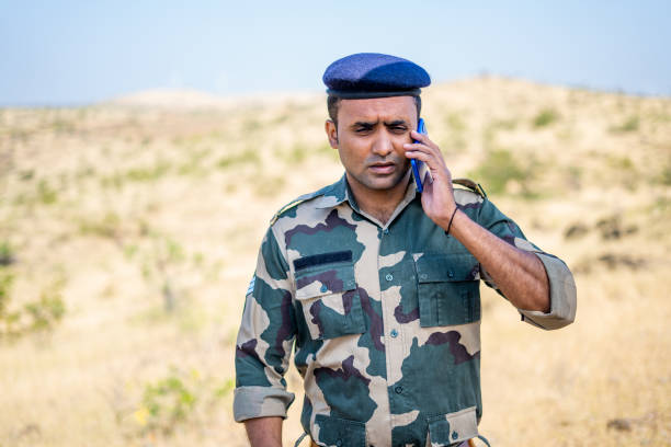 istock Panic soldier while talking on mobile phone during miliary service - concept of stressful, healthcare and professional occupation 1384461973