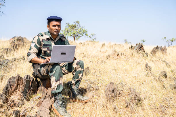 istock Serviceman using laptop on top of mountain for gathering data - concept of intelligence, internet connection, communication and surveillance 1384462364