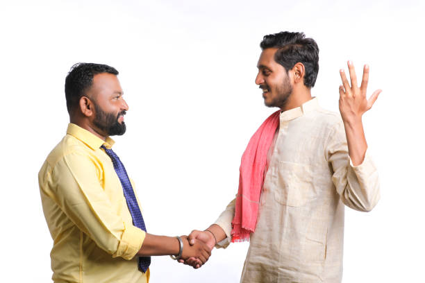 Young indian officer shake hand with farmer on white background.