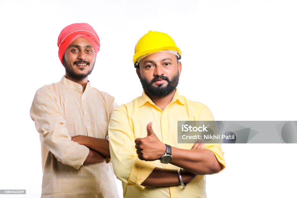 Young indian engineer with farmer on white background. 25-29 Years Stock Photo