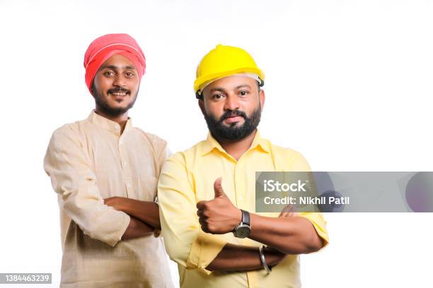 Young Indian Engineer With Farmer On White Background Stock Photo - Download Image Now