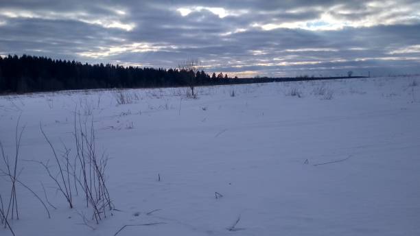 istock Amazing clouds over a snow-covered field 1384465157